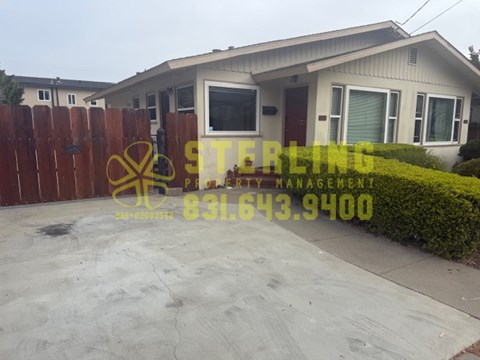 A Sterling Property Management sign is displayed in front of a house.