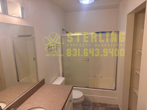 A bathroom with a Sterling Property Management logo on the glass.