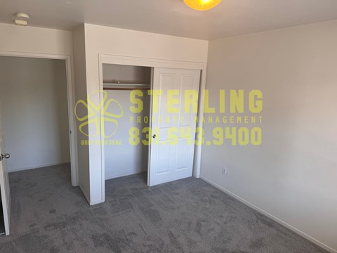 A room with Sterling Management logo and number on the wall.