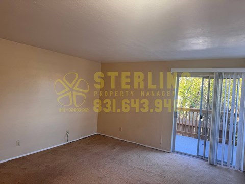 A Sterling Property Manager sign is on the wall of an empty room.