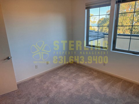 A room with a Sterling Property Management logo and contact number on the wall.