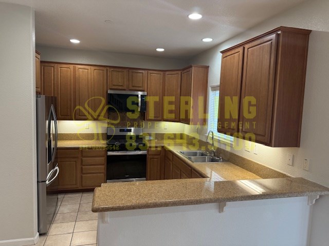 A kitchen with wooden cabinets and a granite countertop.