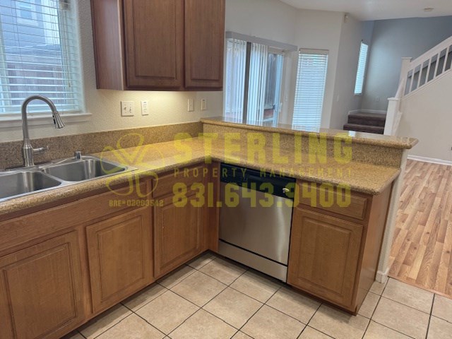 A kitchen with a sink and a yellow caution tape across it.
