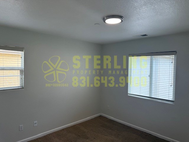 A Sterling Property Management logo is on the wall of an empty room.