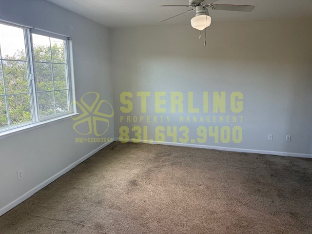 A room with a Sterling Property Management logo and contact number on the wall.