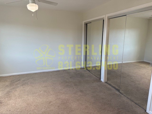 A room with a carpeted floor and a glass door.