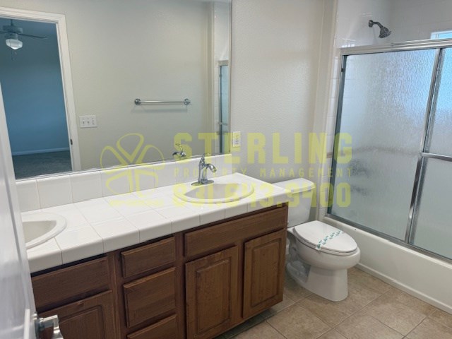 A bathroom with a sink, toilet, and shower.