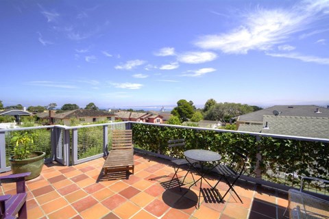a roof terrace with a view of the ocean
