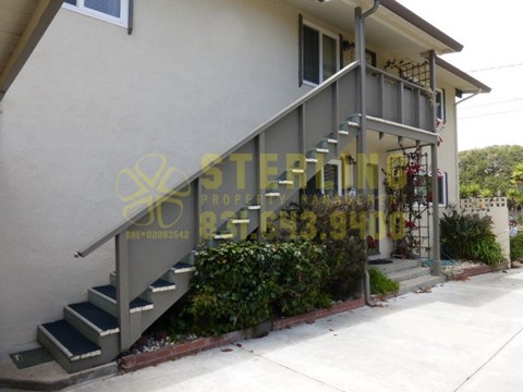A house with a staircase leading to the front door.