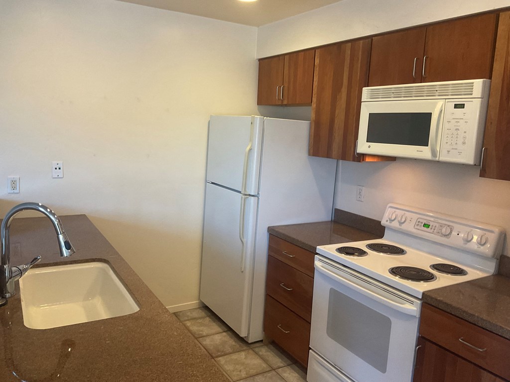 a kitchen with a stove microwave and refrigerator