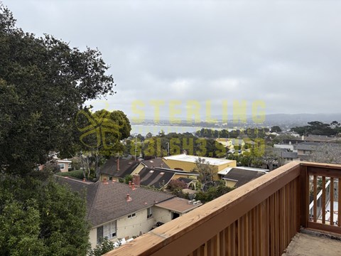 A view from a balcony overlooking a residential area.