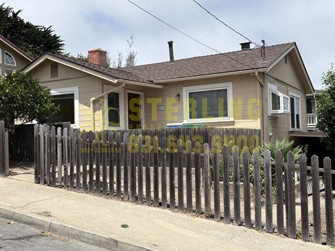 A house with a fence in front of it.