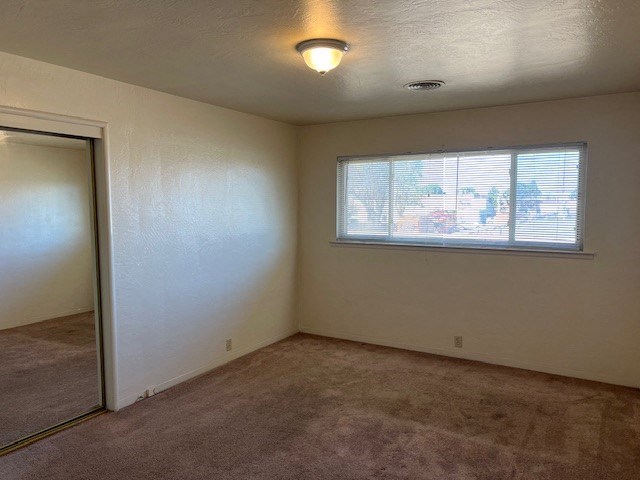 an empty room with a window and a door