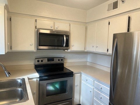 a kitchen with a stove microwave and refrigerator
