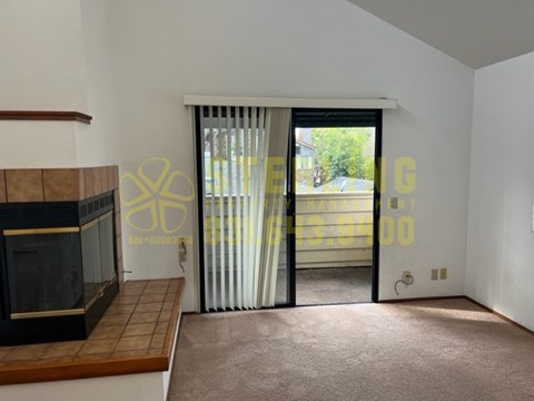 A room with a fireplace and a carpeted floor.