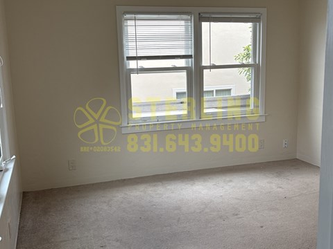 A room with a window and a wall decal that says "Energy Management" and a phone number.