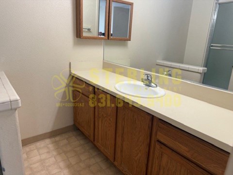 A bathroom with a sink and a mirror.