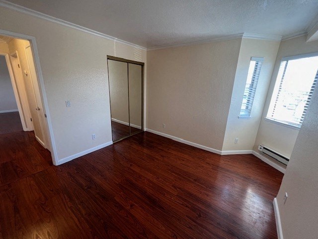an empty living room with a wooden floor and a closet