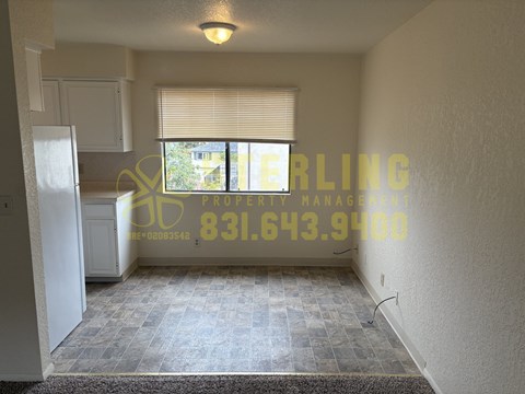 A room with a tiled floor and a window with blinds.