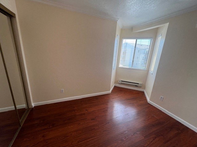 an empty room with wooden floors and a window