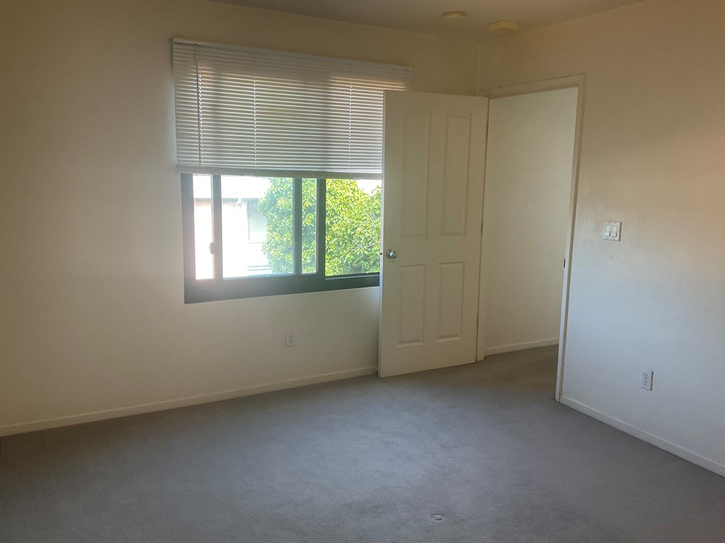 a living room with a window and a door