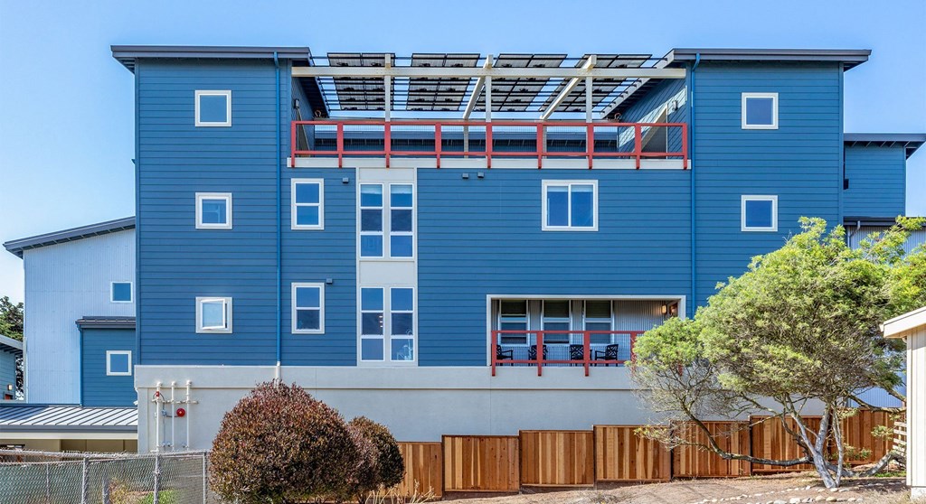 a blue building with a balcony on top of it