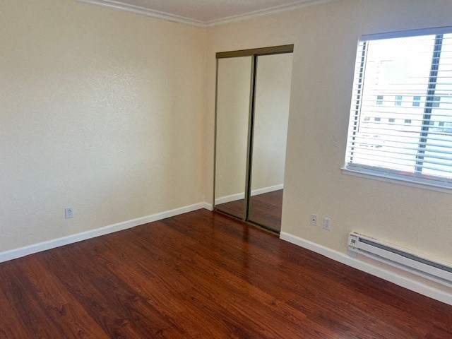 an empty room with a wood floor and a window