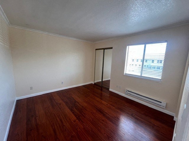 an empty room with wooden floors and a window