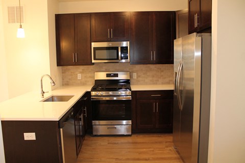a kitchen with stainless steel appliances and wooden cabinets