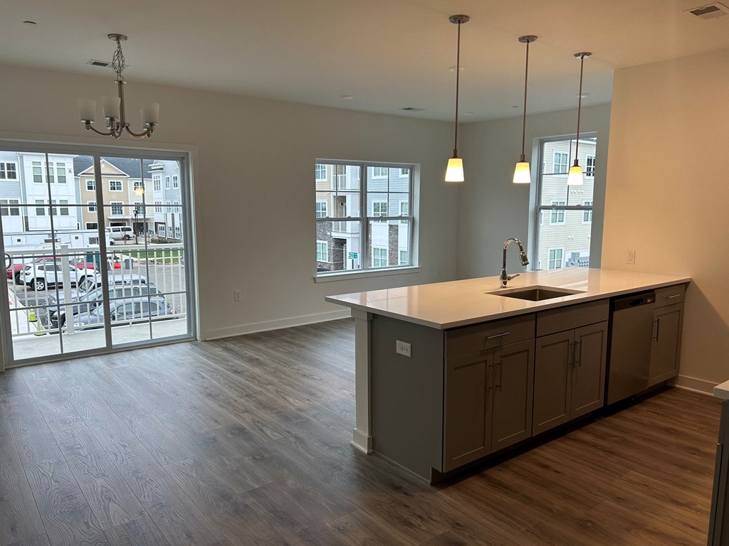 an empty kitchen with an island and a large window