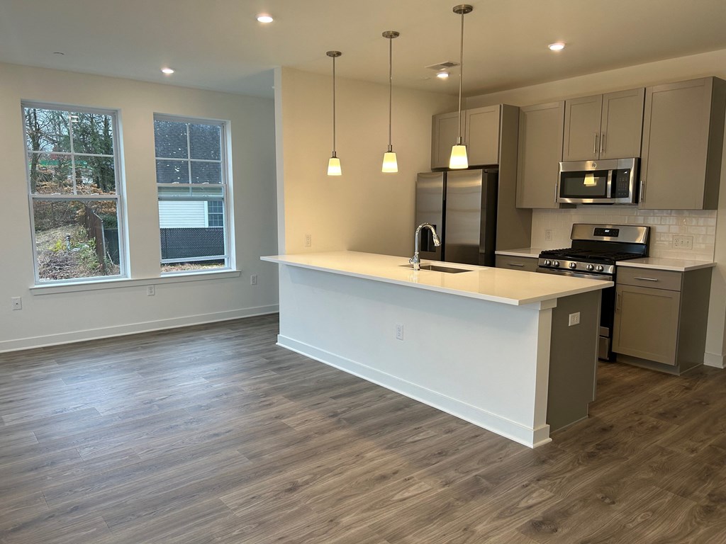 an empty kitchen with an island in the middle of it