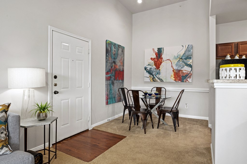 an open living room and dining room with a table and chairs at Bella Madera Apartments, Texas