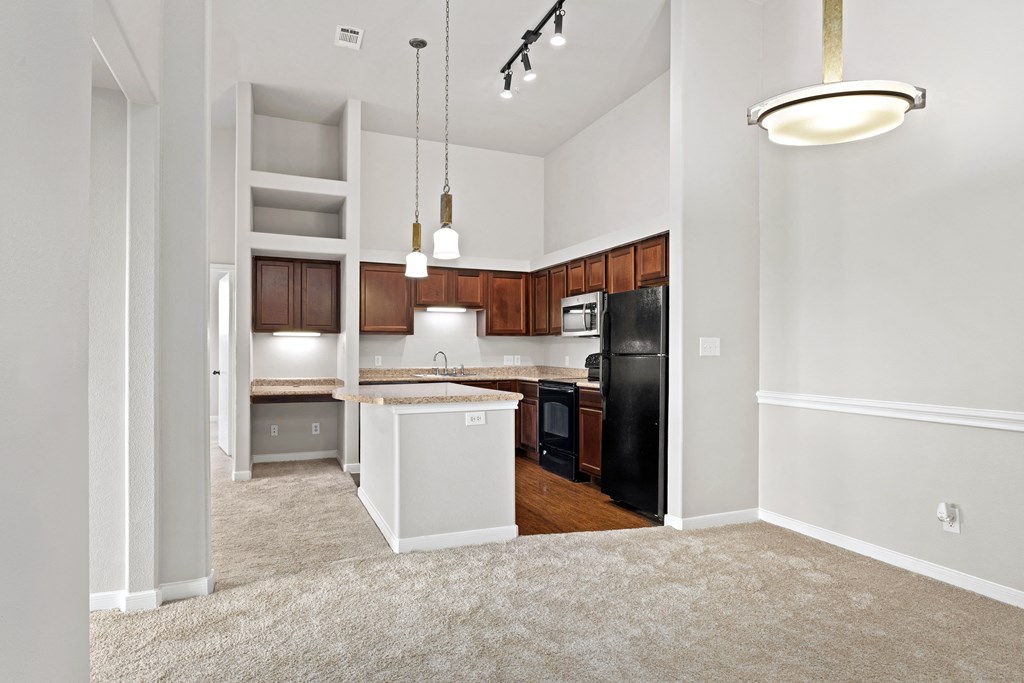 an empty dining room next to a kitchen at Bella Madera Apartments, Texas, 75056