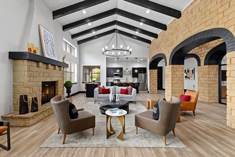 a living room with couches and chairs and a fireplace