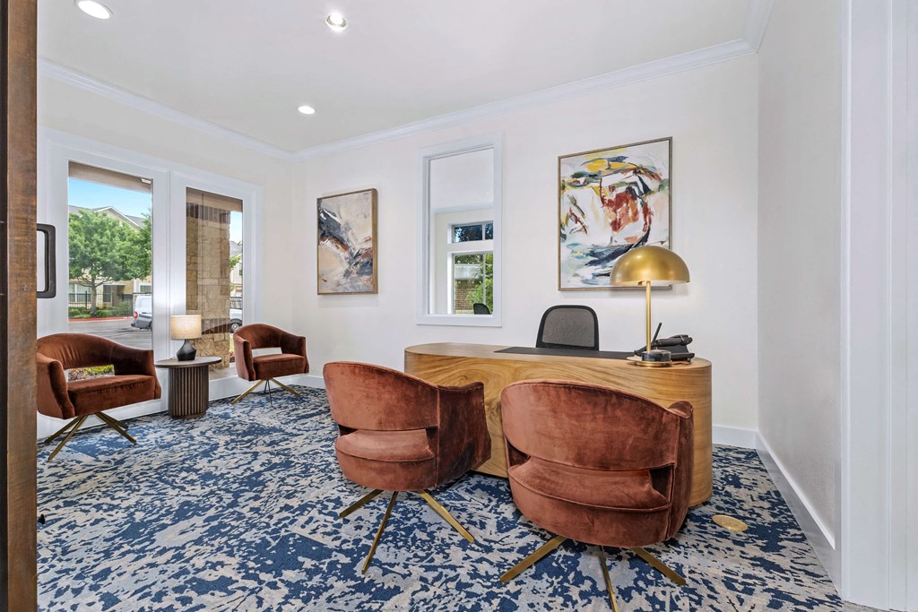 a home office with a desk and chairs