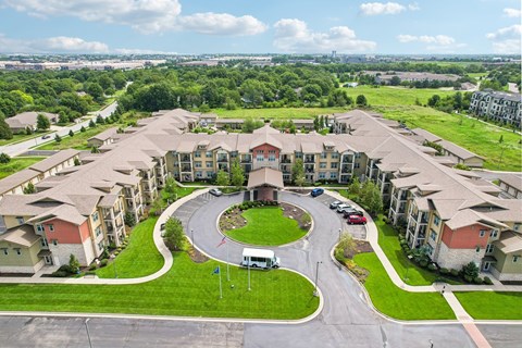 A large apartment complex with a circular driveway in the middle.