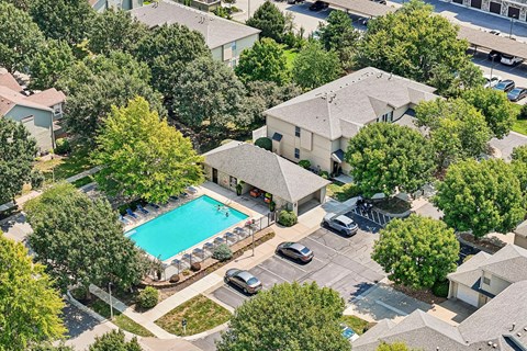 A bird's eye view of a residential area with a swimming pool.