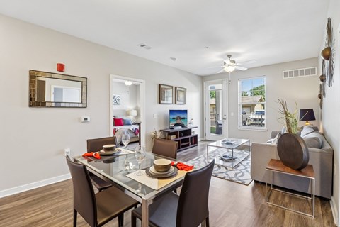 A dining room with a glass table and chairs.