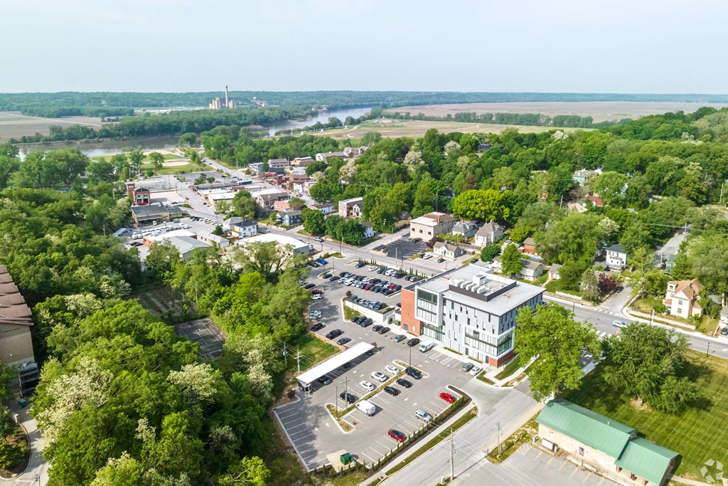 an aerial view of a city with cars in a parking lot
