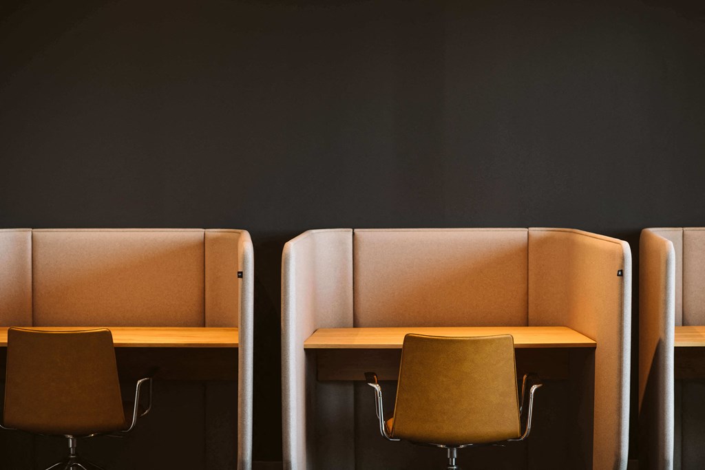 yellow chairs at desks with small privacy walls around them at The Apex at CityPlace, Overland Park, 66210