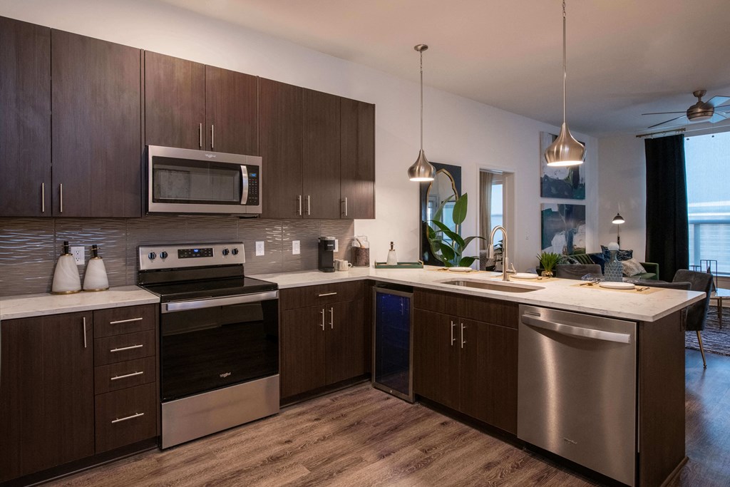 kitchen with brown cabinets and stainless steel appliances at The Apex at CityPlace, Kansas, 66210