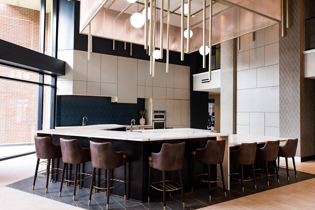 indoor bar with white counters at two hights and chairs around the countertop at The Apex at CityPlace, Overland Park, KS