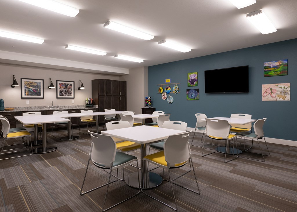 Activity Center with tables, chairs, and craft materials at Aspen Ridge 55+ Active Adult Community