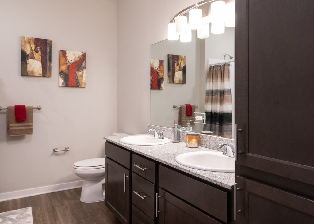 A full bathroom with double-vanity at Aspen Ridge 55+ Apartment Community in Olathe, KS