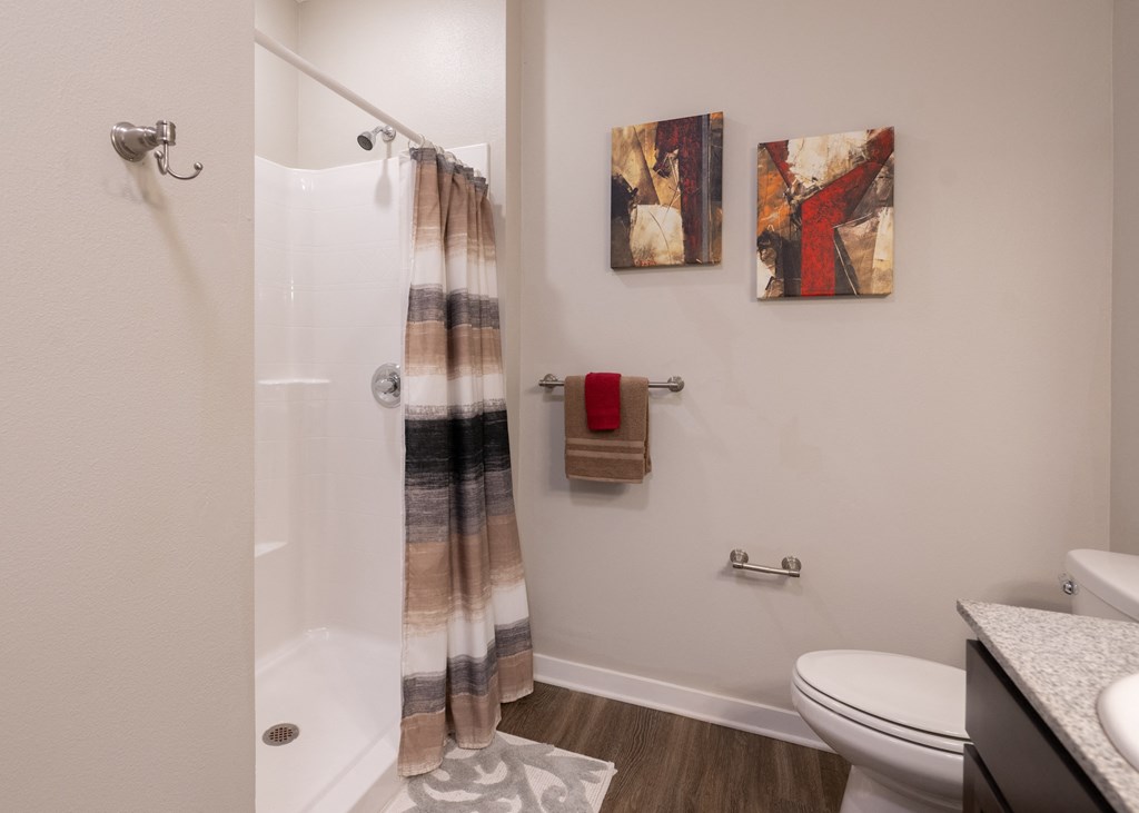 A full bathroom with a walk-in shower at Aspen Ridge 55+ Apartment Community in Olathe, KS
