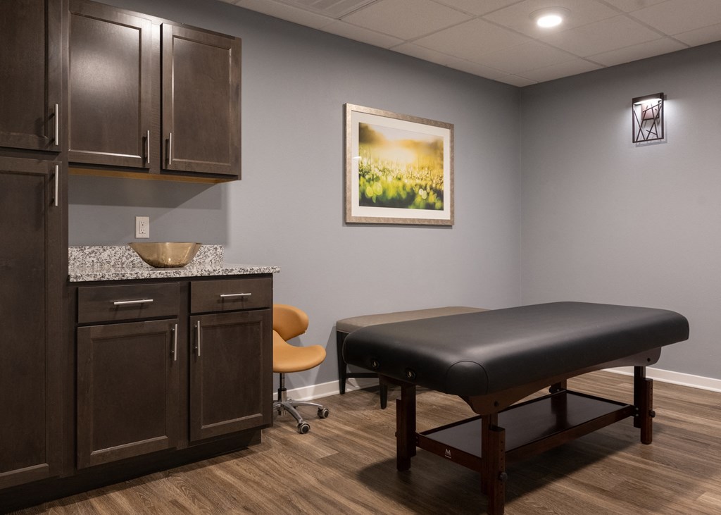 A massage table and a chair at Aspen Ridge 55+ Active Adult Community