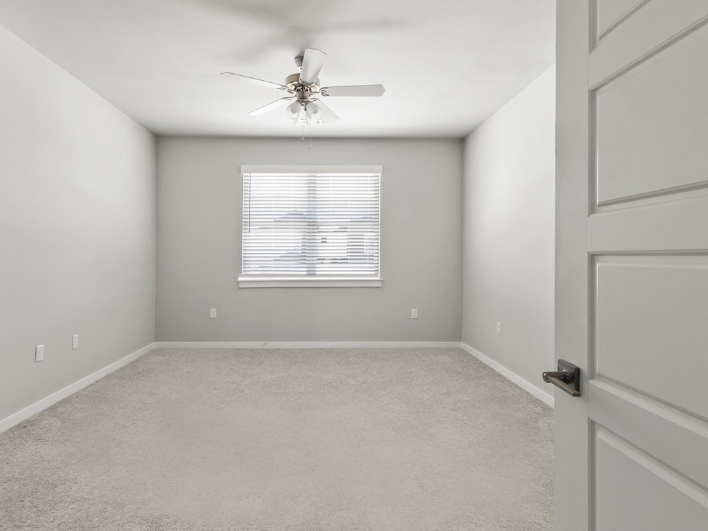 an empty room with a ceiling fan and a window at Hillcrest Village, Arkansas, 72762