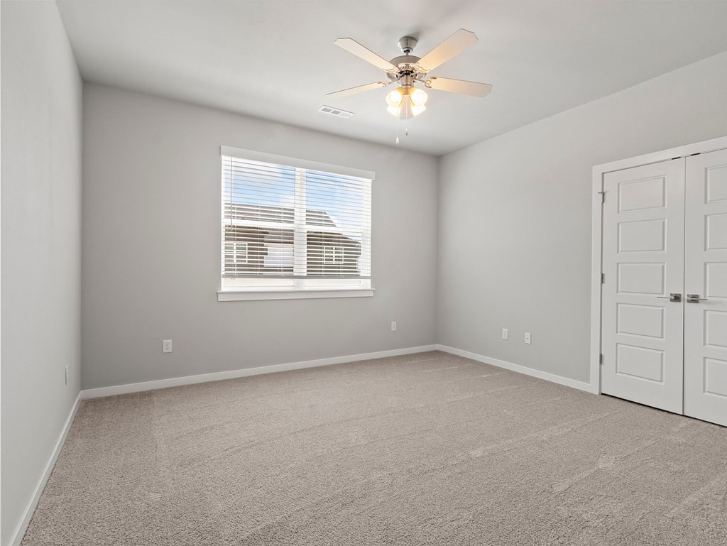 an empty room with a ceiling fan and a window at Hillcrest Village, Springdale, AR 72762