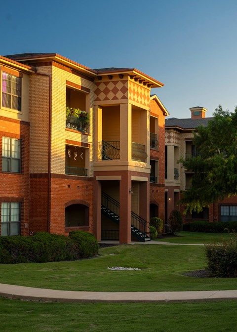 A large multi-story building with a balcony on the second floor.