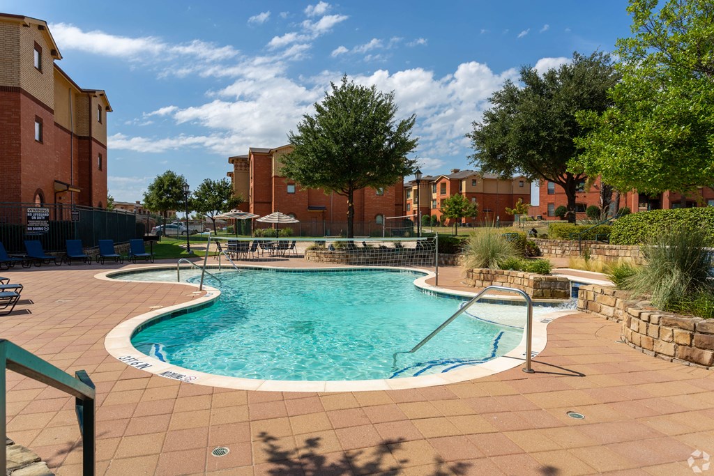 Swimming pool with in-pool volleyball net at Bella Madera Apartments, Lewisville Texas